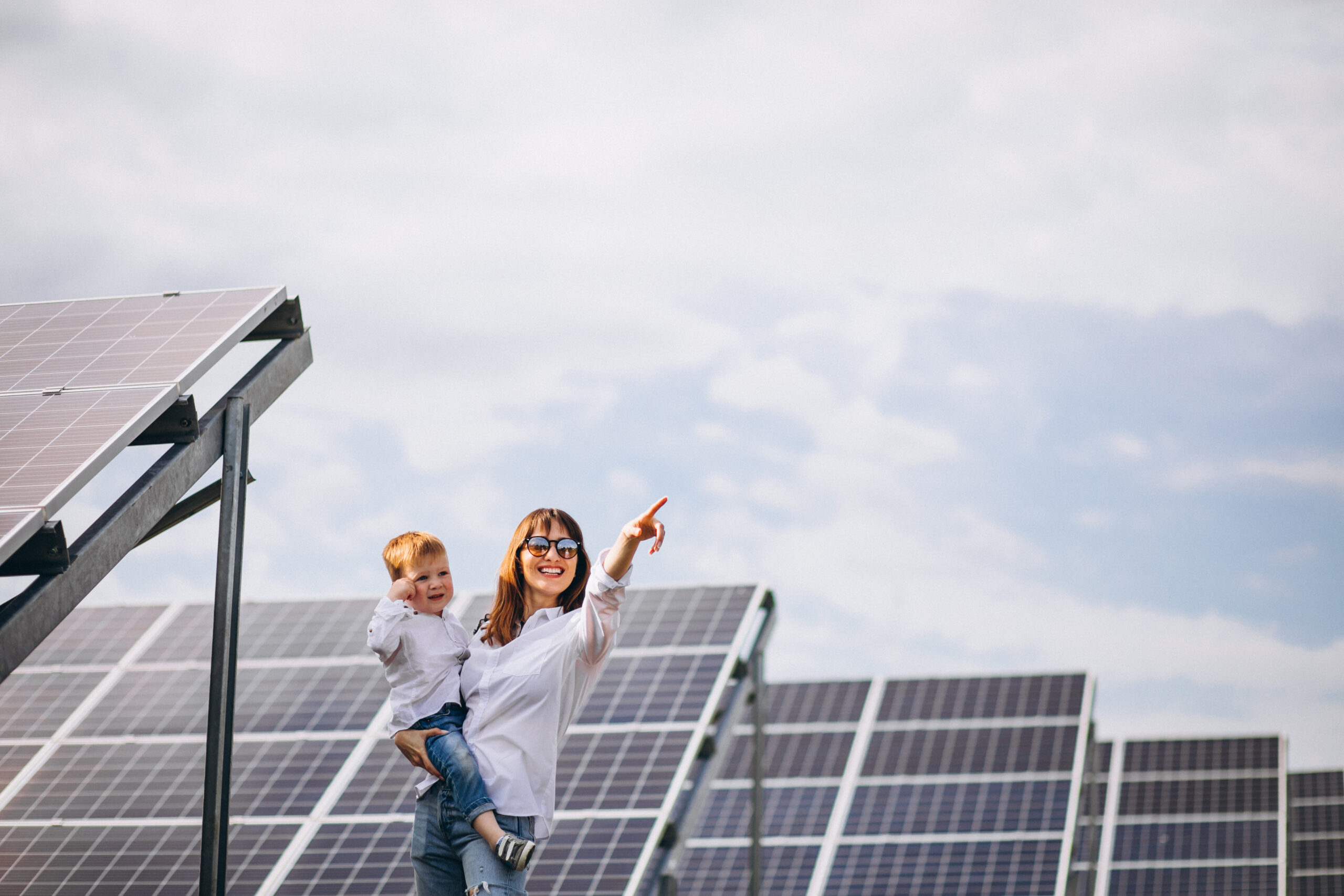 mother with her little son by solar panels