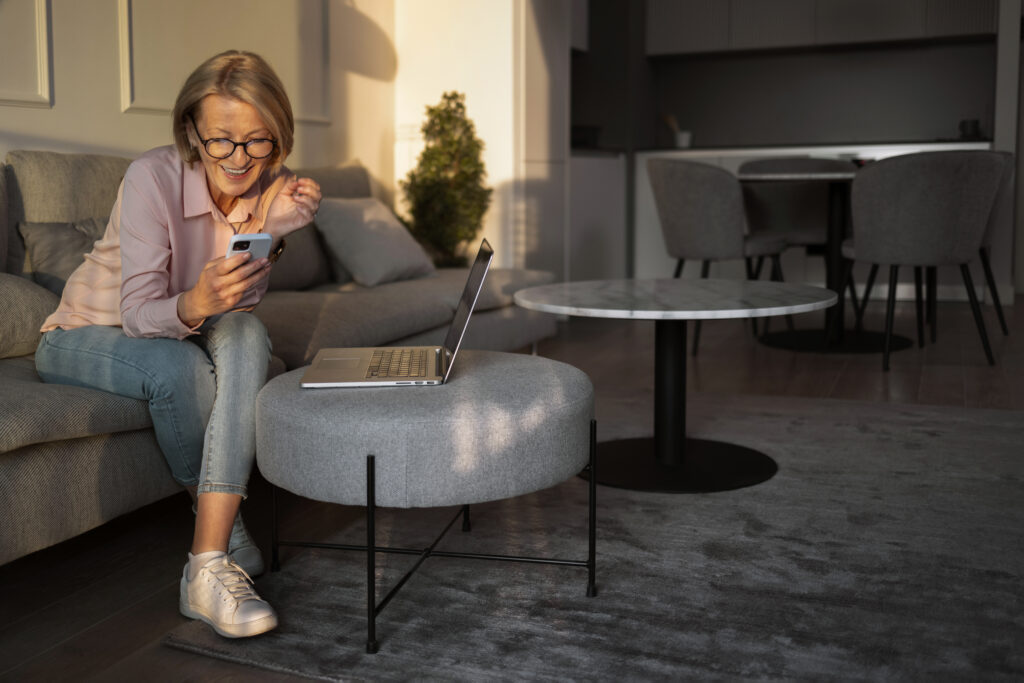 full shot woman taking break with smartphone